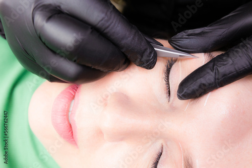 Young Caucasian Woman on the brow beauty procedures. Professional care for face. Brows coloring  wax and lamination