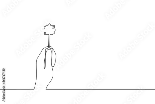 Single continuous line drawing hand holding a key to unlock a door or a safe. Hand holds key. The concept of solving any problems, opening up new opportunities. One line art. Vector illustration.