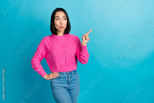 Photo of playful young japanese girl pink knitwear waist direct finger empty pouted lips space look new proposition isolated on blue color background