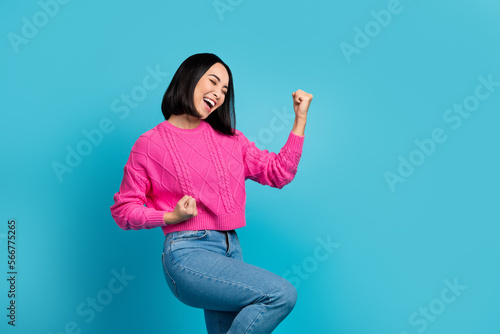 Profile photo of delighted cheerful person raise fists achieve accomplishment isolated on blue color background photo