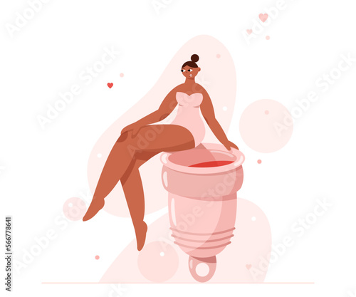 A woman sits on a menstrual cup.