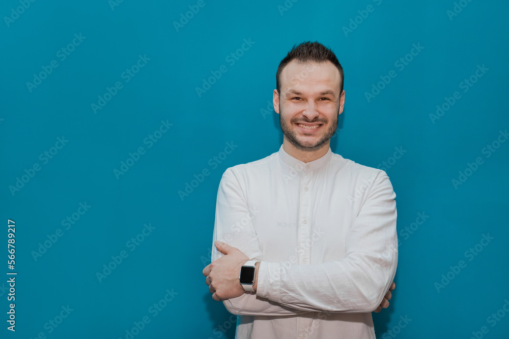 Positive and cheerful guy Caucasian appearance stylish businessman in a white shirt on a blue background Positive and cheerful guy Caucasian appearance stylish businessman in a white shirt on a blue background