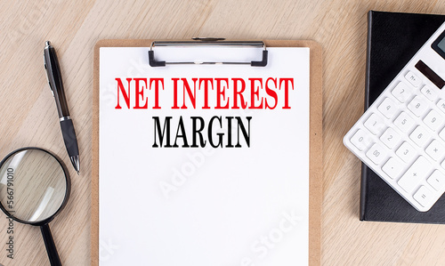 NET INTEREST MARGIN text on a clipboard on wooden background