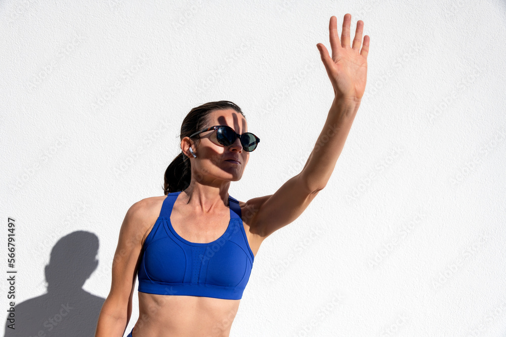 woman shielding her face from the strong sunlight woman shielding her face from the strong sunlight