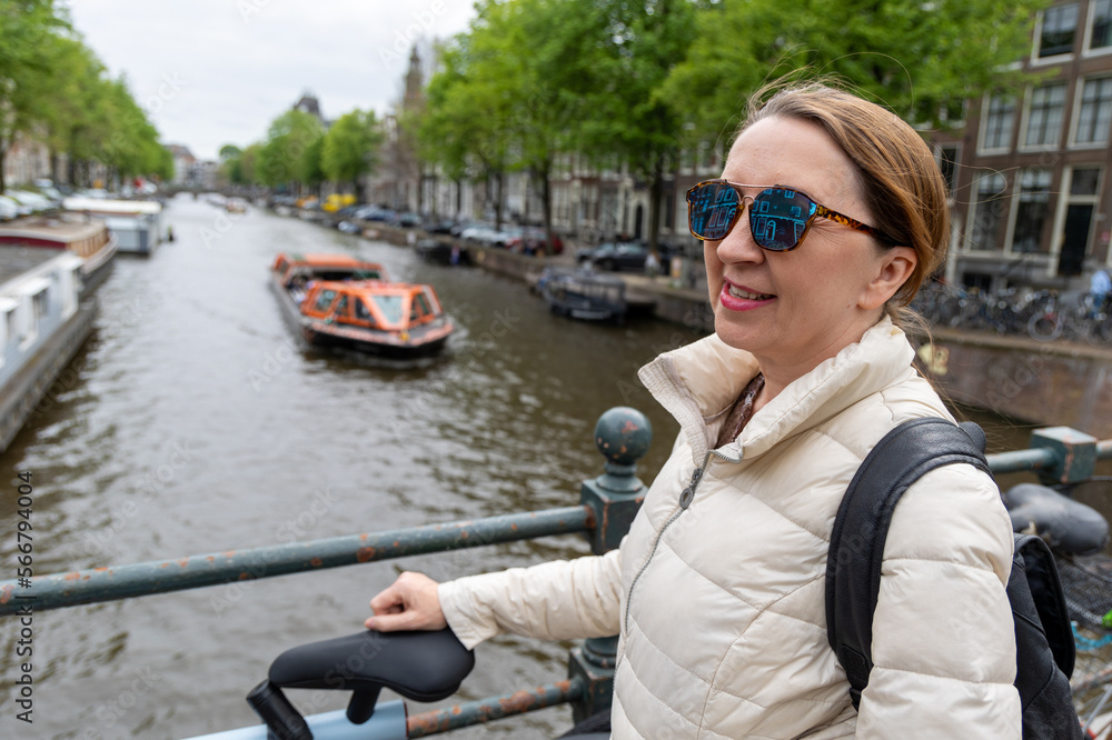 Portrait of a woman against the background of a canal in Amsterdam