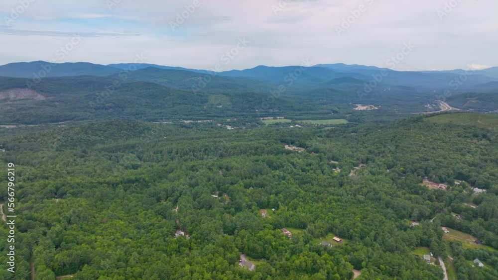 Flying over the Campton Mountain in summer with White Mountain National Forest at the background in town of Campton, New Hampshire NH, USA. Flying over the Campton Mountain in summer with White Mountain National Forest at the background in town of Campton, New Hampshire NH, USA.