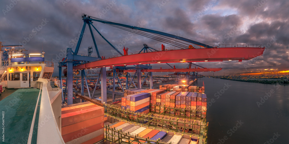 The container ship at industrial container terminal loading and discharging by shore gantrys or quay cranes, aerial view industry crane. Global business cargo freight shipping.