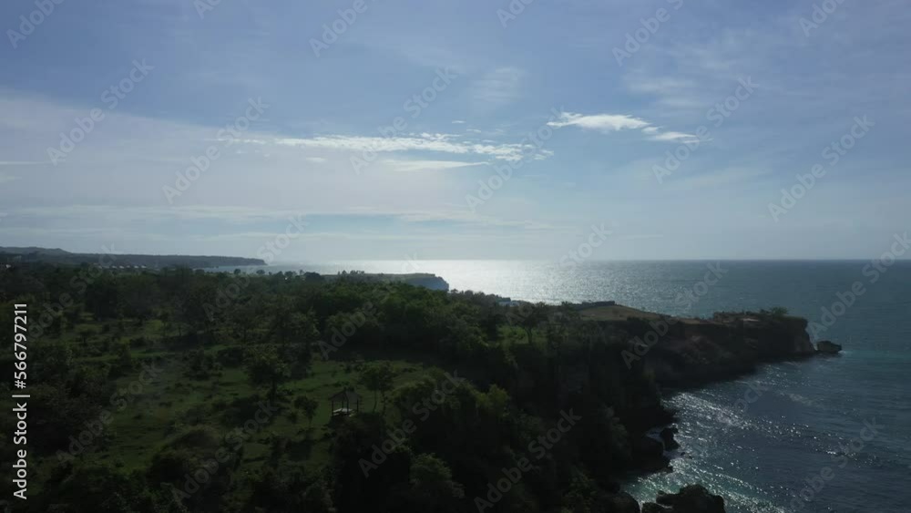 Sea coast in Bali aerial shot against the sun Sea coast in Bali aerial shot against the sun