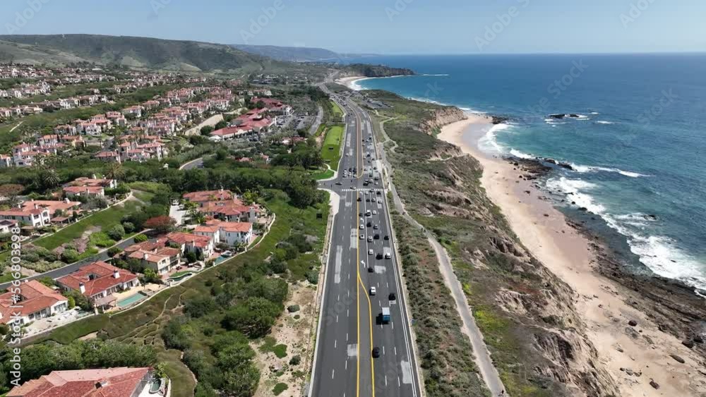 Aerial view of scenic Pacific Coast Highway on the Orange County California coastline with views of the ocean, beach, freeway and luxury residential vacation homes. Aerial view of scenic Pacific Coast Highway on the Orange County California coastline with views of the ocean, beach, freeway and luxury residential vacation homes.