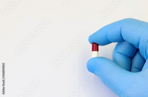 Doctor's hand with a capsule, antibiotic, or medicine pill