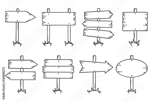 Wooden road signs doodle set. Wooden direction signs and arrows in sketch style.  Hand drawn vector illustration isolated on white background.