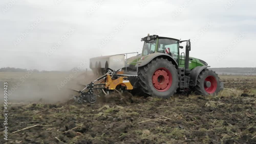 Tractor working in the field. Autumn tillage. Deep ripping with powerful tractor Tractor working in the field. Autumn tillage. Deep ripping with powerful tractor