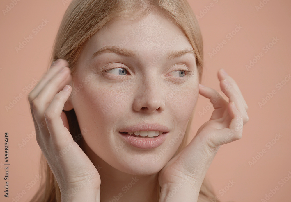 Beautiful young woman with absolutely no makeup gently smiles against neutral brown pastel background. Studio shot, soft lighting Beautiful young woman with absolutely no makeup gently smiles against neutral brown pastel background. Studio shot, soft lighting