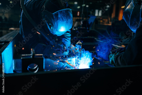 Welders using gas torches in factory.