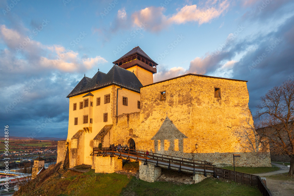 The Trencin Castle above the town of Trencin at sunset, Slovakia, Europe.