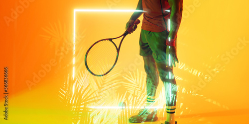 Illuminated plants and square over low section of african american male tennis player with racket