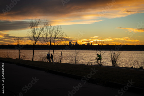 Couple And Cyclist At Sunset
