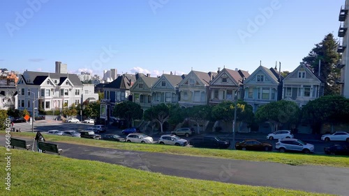 Painted Ladies Victorian houses. Historic Victorian style houses and trees growing under cloudy sky at Alamo Square in California.