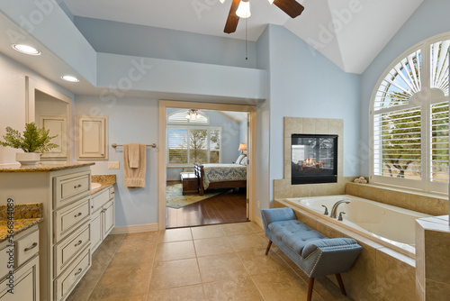 Master bathroom with a fireplace
