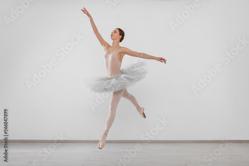 Young ballerina practicing dance moves in studio