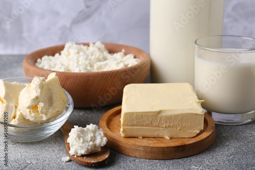 Piece of tasty homemade butter and dairy products on grey table