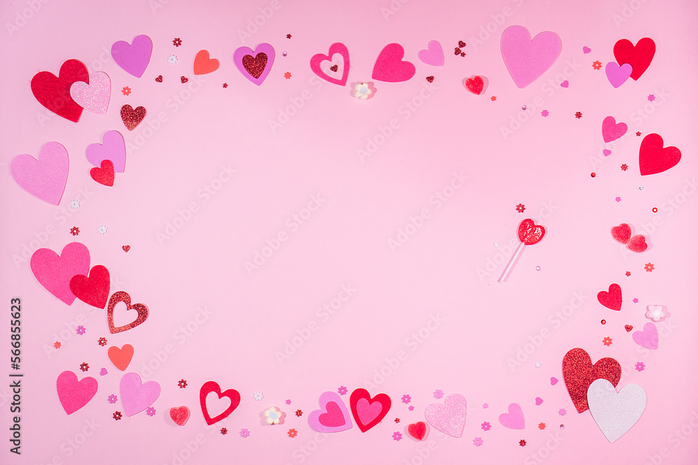 Valentine’s Day. Pink background with red and pink hearts, sweets of heart and sparkles. 
