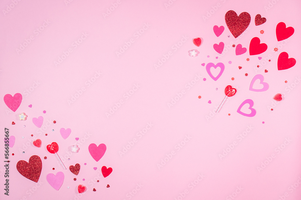 Valentine’s Day. Pink background with red and pink hearts, sweets of heart and sparkles. 