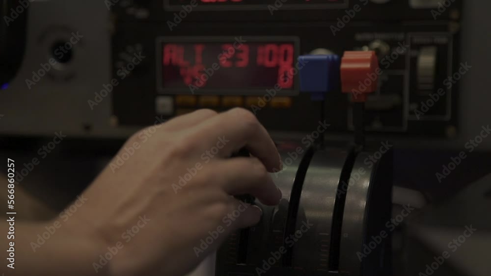 Close of a hand pulling a lever in a flight simulator cockpit Close of a hand pulling a lever in a flight simulator cockpit