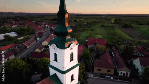 Aerial orbit view of reformed protestant church clock tower at sunset photo
