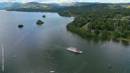 Cinematic aerial drone view of Bowness-on-Windermere. Showing the small lakeland town and the Lake. Boats, cruse, small ships. Lake District National Park, Cumbria, UK photo