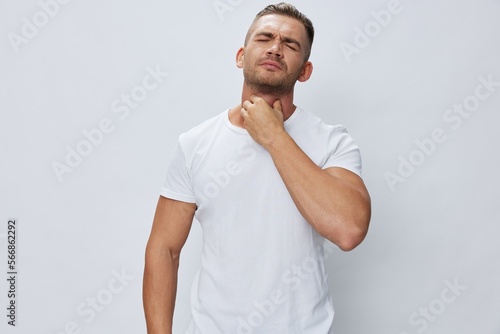 Man sore throat and cough, cold and flu, allergies, pain, in white t-shirt on white isolated background, copy space