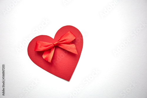 Red heart shape on abstract pink background in valentine's day love concept with sweet and romantic moment. © areporter