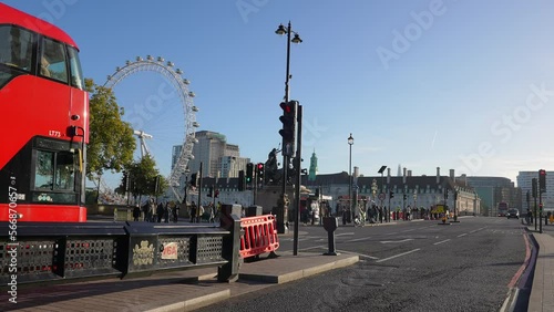 City center of London near the Big Ben and Westminster Bridge with red double decker busses crossing London, England, United Kingdom. photo