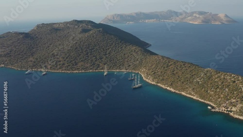 Aerial view of Mediterranean bay of Kas in Turkey. Panoramic view in showing bay, yachts, sailing boats, and surrounding mountains landscape including Greek island of Kastellorizo photo