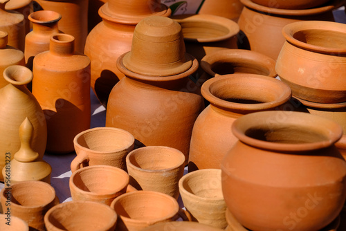 Terracotta, pot, cup kitchen souvenirs pile at street handicraft pottery shop. handmade terracotta Products in handicraft market in Pune, India. photo