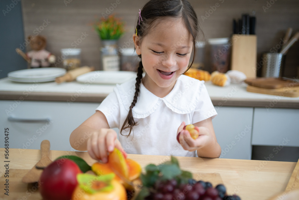 The child is playing fruits. children lying on toy kitchen cooking. Kids Educational, creative games. The child is playing fruits. children lying on toy kitchen cooking. Kids Educational, creative games.