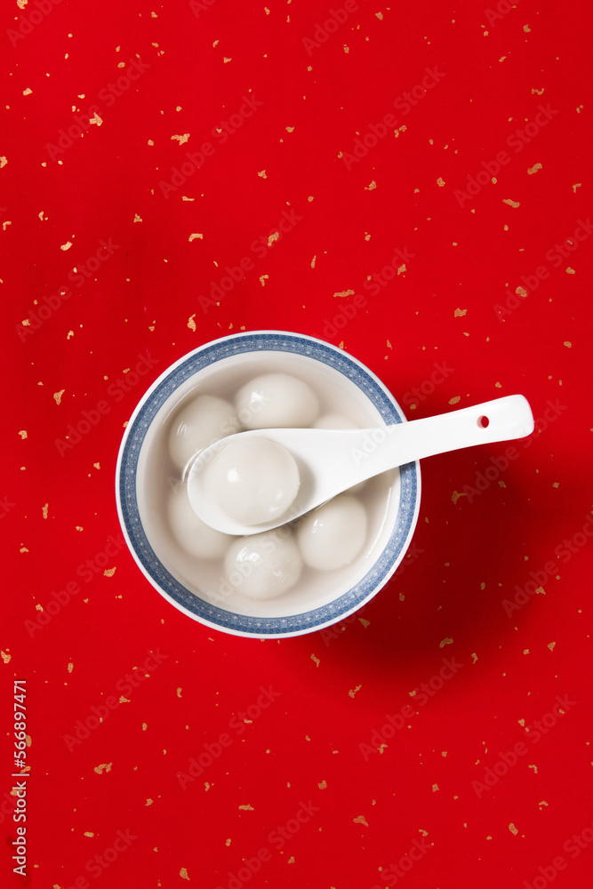 Tang Yuan(sweet dumplings balls) in a bowl.traditional cuisine food on red background. Tang Yuan(sweet dumplings balls) in a bowl.traditional cuisine food on red background.