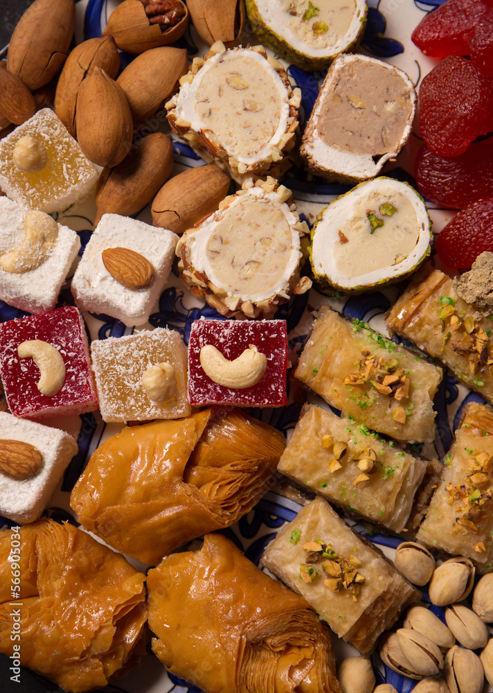 A various oriental sweets and nuts on a dark background, close up