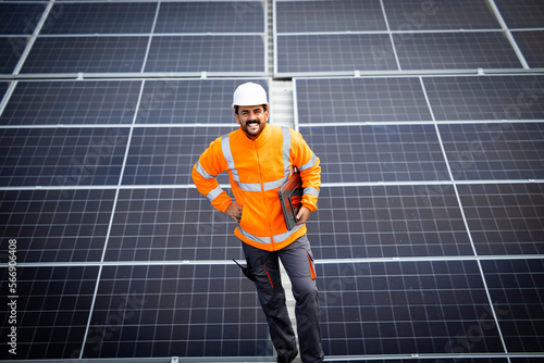 Portrait of solar panel engineer standing inside sustainable energy power plant.