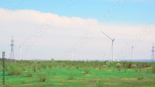 Horizontal axis wind turbine, wind turbines. Clean energy system. Large windmills with blades in a field at sunset. Windmill silhouettes, Alternative energy photo