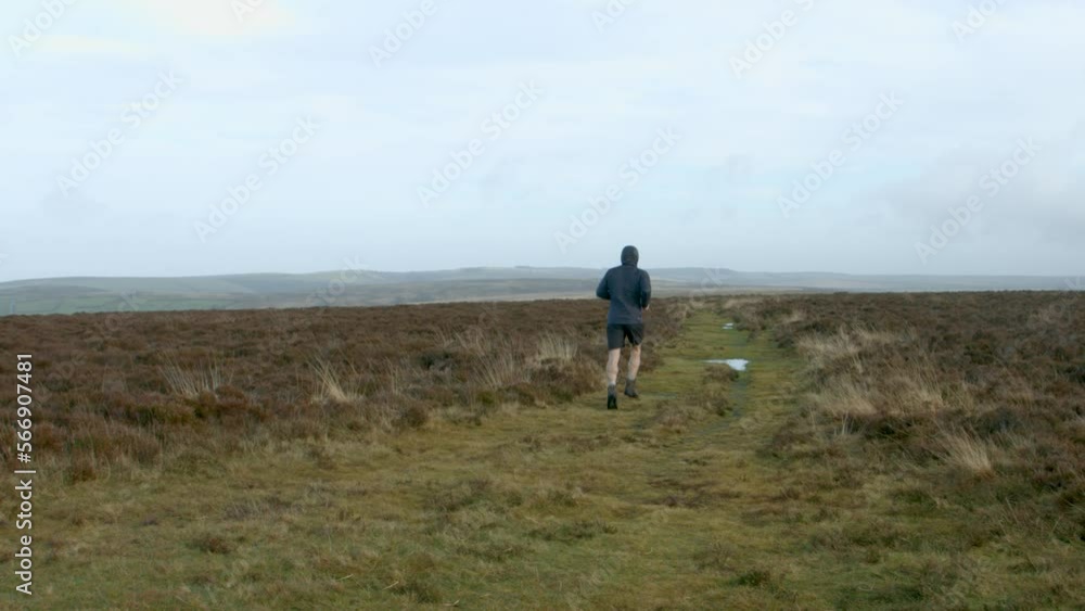 Male Marathon Athlete Running Away from Camera on a Training Run Over Exmoor UK 4K Male Marathon Athlete Running Away from Camera on a Training Run Over Exmoor UK 4K
