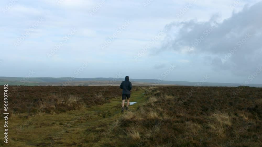 Male Athlete Running Past Camera Training for Marathon Over Rural Countryside in Exmoor Maintaining Healthy Lifestyle UK 4K Male Athlete Running Past Camera Training for Marathon Over Rural Countryside in Exmoor Maintaining Healthy Lifestyle UK 4K