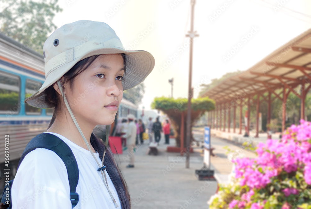 Portrait of a young Asian girl at a train station