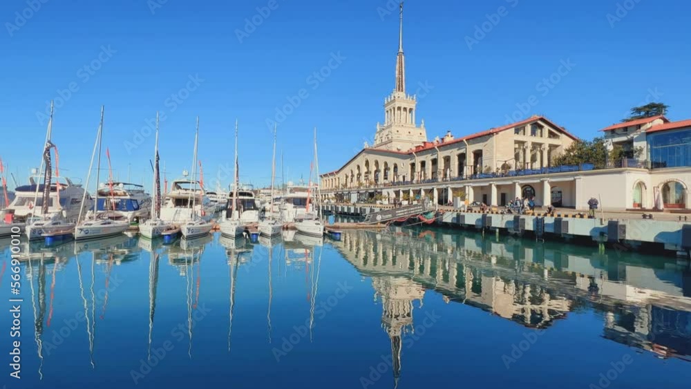 SOCHI, RUSSIA - January 2023: Marine Station. View of the commercial Sea port of Sochi. The building of the Marine Passenger Terminal is reflected in the water. A seaport on the Black Sea. SOCHI, RUSSIA - January 2023: Marine Station. View of the commercial Sea port of Sochi. The building of the Marine Passenger Terminal is reflected in the water. A seaport on the Black Sea.