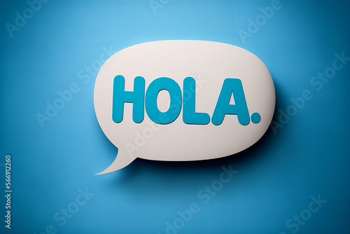 Hola.  Spanish salutation word to welcome someone or initiate a conversation. Design with letters on paper speech bubble over blue background. Communication concept, introduction. photo