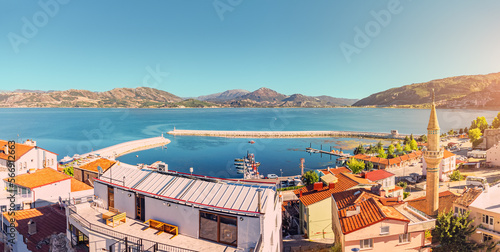 Aerial view over rooftops and mosque minaret in Egirdir, Isparta province in Turkey. Travel sightseeing and religious tourism.