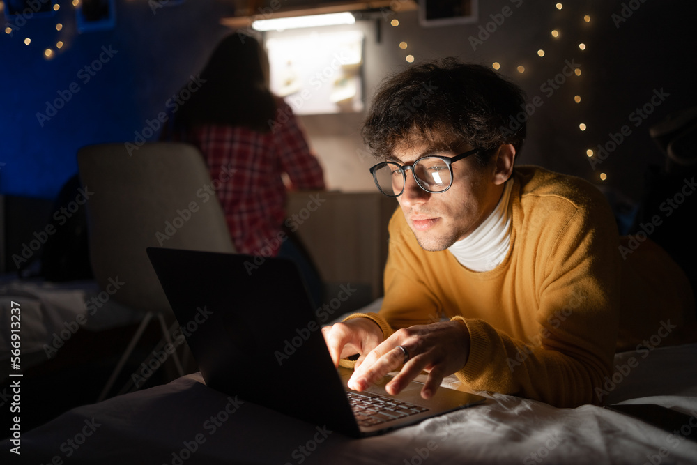 College student studying at night from home in his room. College student studying at night from home in his room.