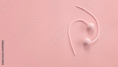 Fitness and healthy sport concept. Pink ropeless jump rope on a pastel pink background. Top view, flat lay, copy space