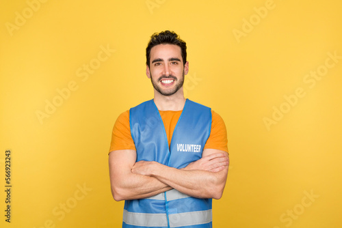Man in volunteer waistcoat with arms crossed
