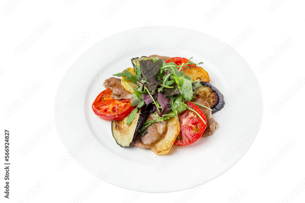 Grilled vegetables with meat on a white plate. Baked slices of tomatoes, eggplant and potatoes. Close-up. Isolated on white background. Grilled vegetables with meat on a white plate. Baked slices of tomatoes, eggplant and potatoes. Close-up. Isolated on white background.